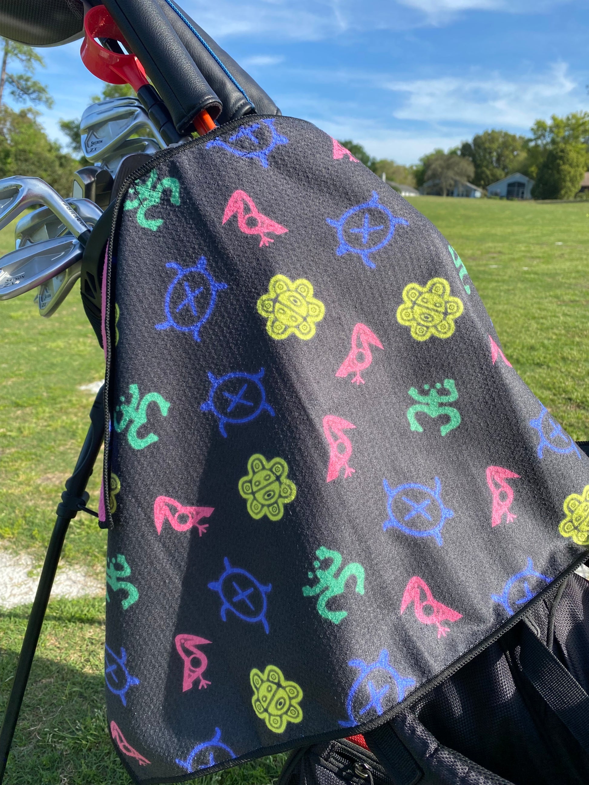 Taino Golf double-sided microfibre waffle towel, featuring a durable, absorbent fabric for cleaning golf clubs and hands, with a native inspired design and Taino Golf branding.