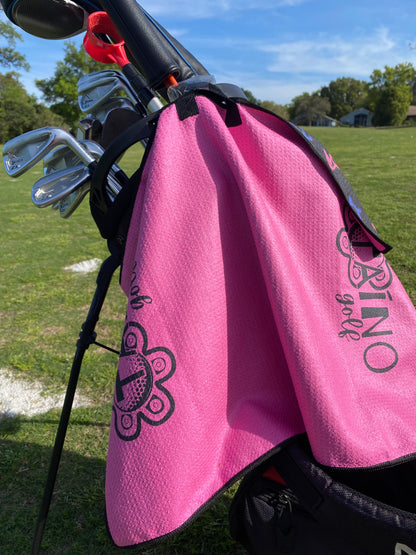 Taino Golf pink, double-sided microfibre waffle towel, featuring a durable, absorbent fabric for cleaning golf clubs and hands, with a native inspired design and Taino Golf branding.