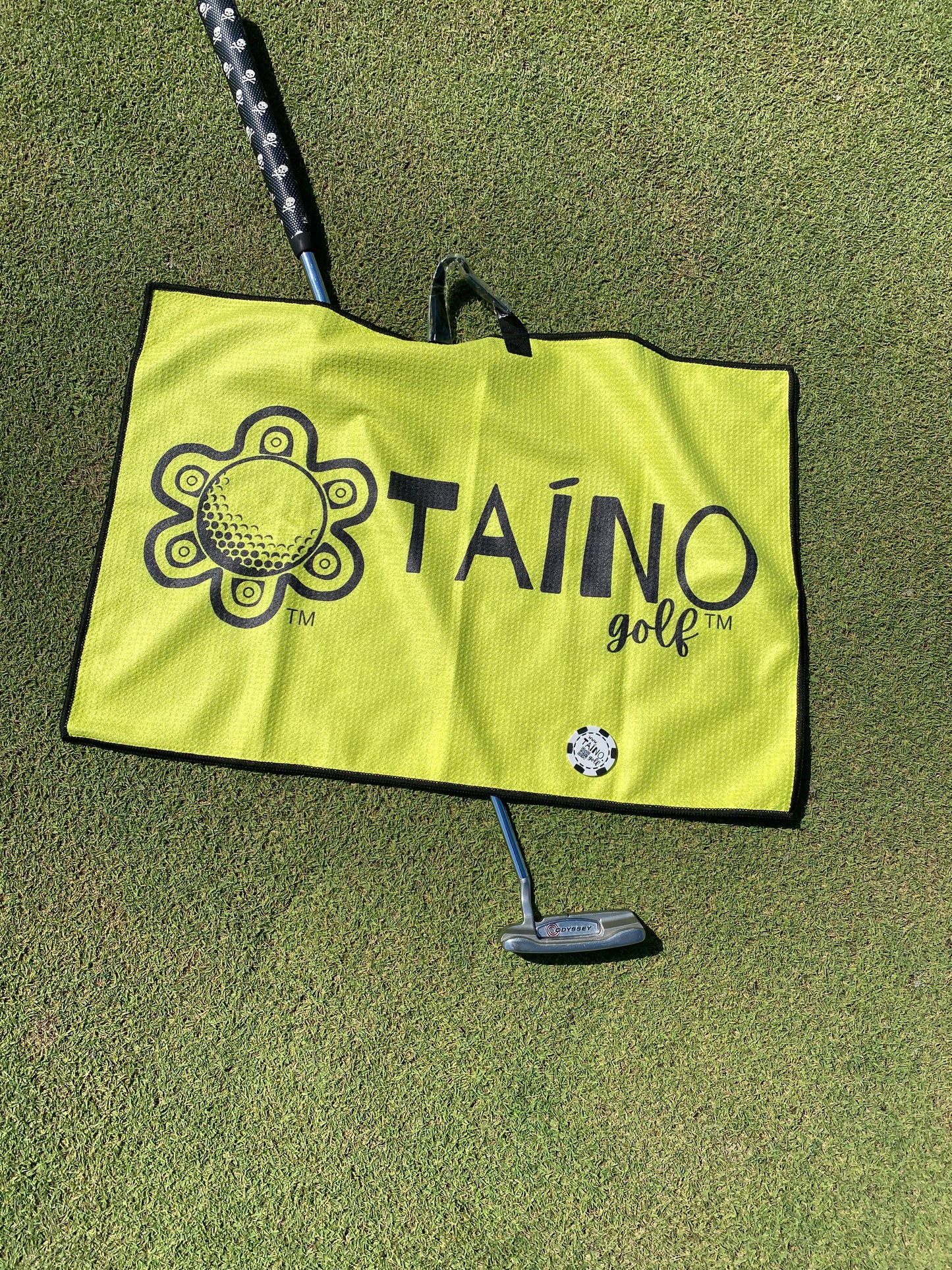 Taino Golf yellow, double-sided microfibre waffle towel, featuring a durable, absorbent fabric for cleaning golf clubs and hands, with a native inspired design and Taino Golf branding.