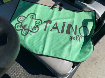 Taino Golf green double-sided microfibre waffle towel, featuring a durable, absorbent fabric for cleaning golf clubs and hands, with a native inspired design and Taino Golf branding.